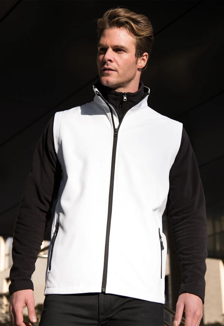 Model wearing the Men's Printable Softshell Bodywarmer R232M in White/Black.