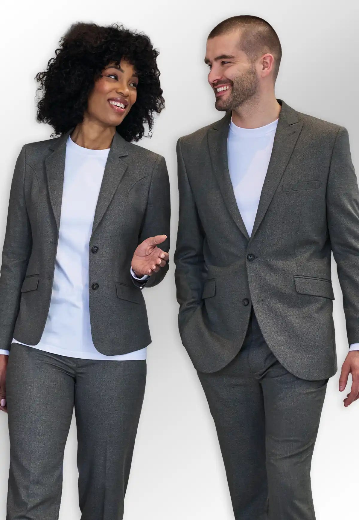 A woman and man wearing Brook Taverner Rapport Collection grey suits
