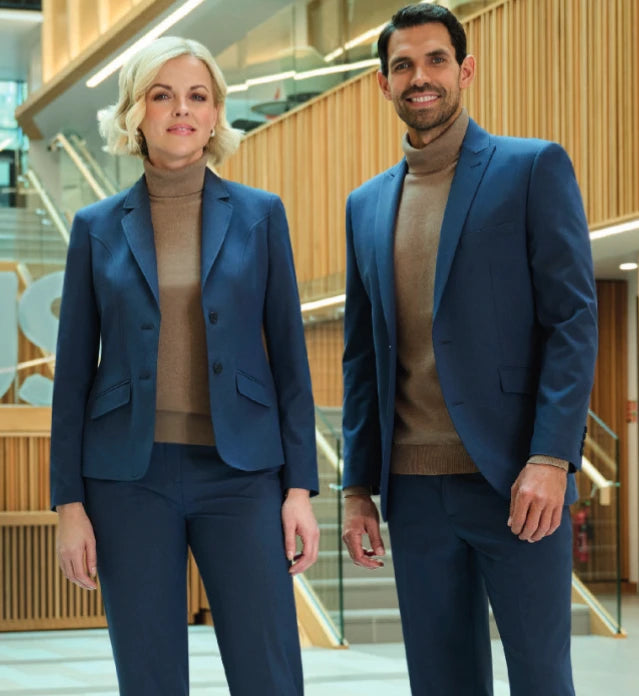 Male & female duo wearing Brook Taverner Rapport collection suit jackets & trousers in Denim Blue