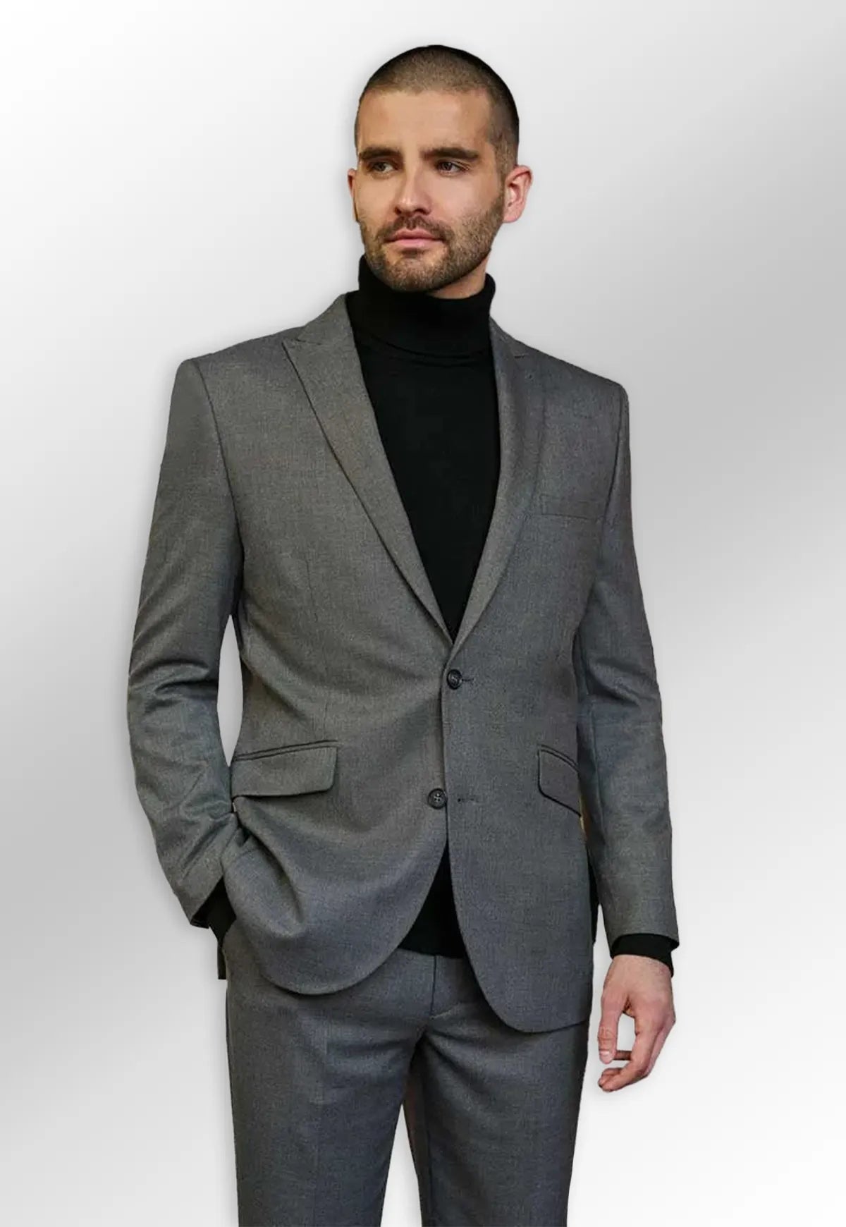 Model wearing grey suit jacket and black turtleneck jumper from the Brook Taverner Rapport Menswear Collection