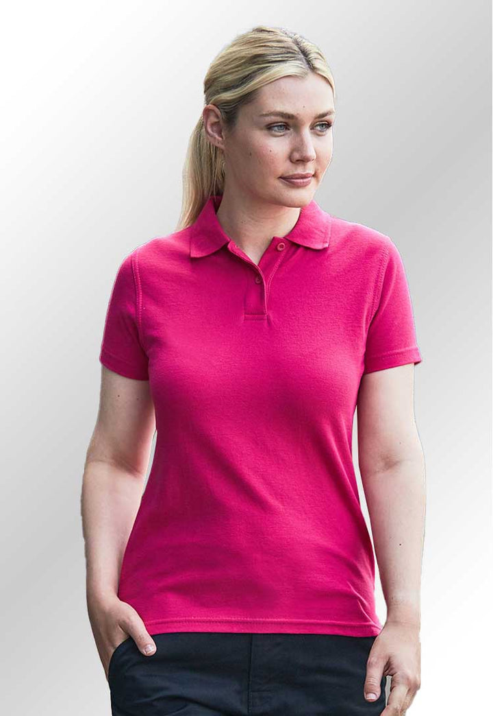 A model wearing the RX01F Women's Prop Polo in Fuchsia