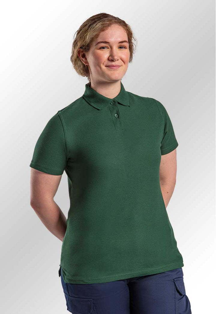 A model wearing the RX01F Women's Prop Polo in Bottle Green