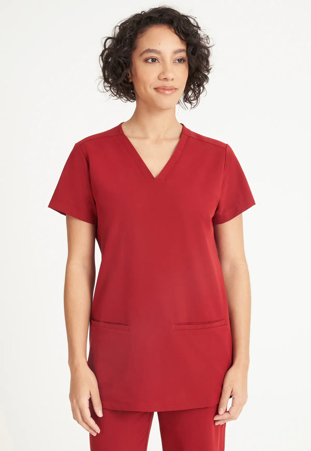 Model wearing the burgundy Simki Ari scrub top