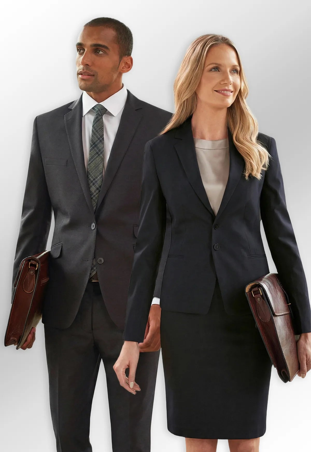 Man and woman in formal office uniforms from the Brook Taverner Sophisticated Collection, standing side by side.
