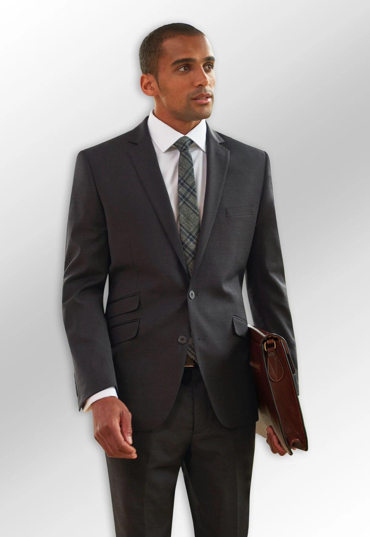 Model wearing a grey suit from the Brook Taverner Sophisticated Menswear Collection.