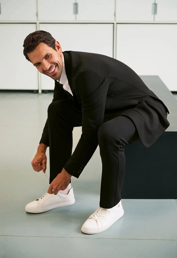 Lifestyle photo of model wearing the Brook Taverner Taurus Jersey Stretch Men's Trousers in Black.