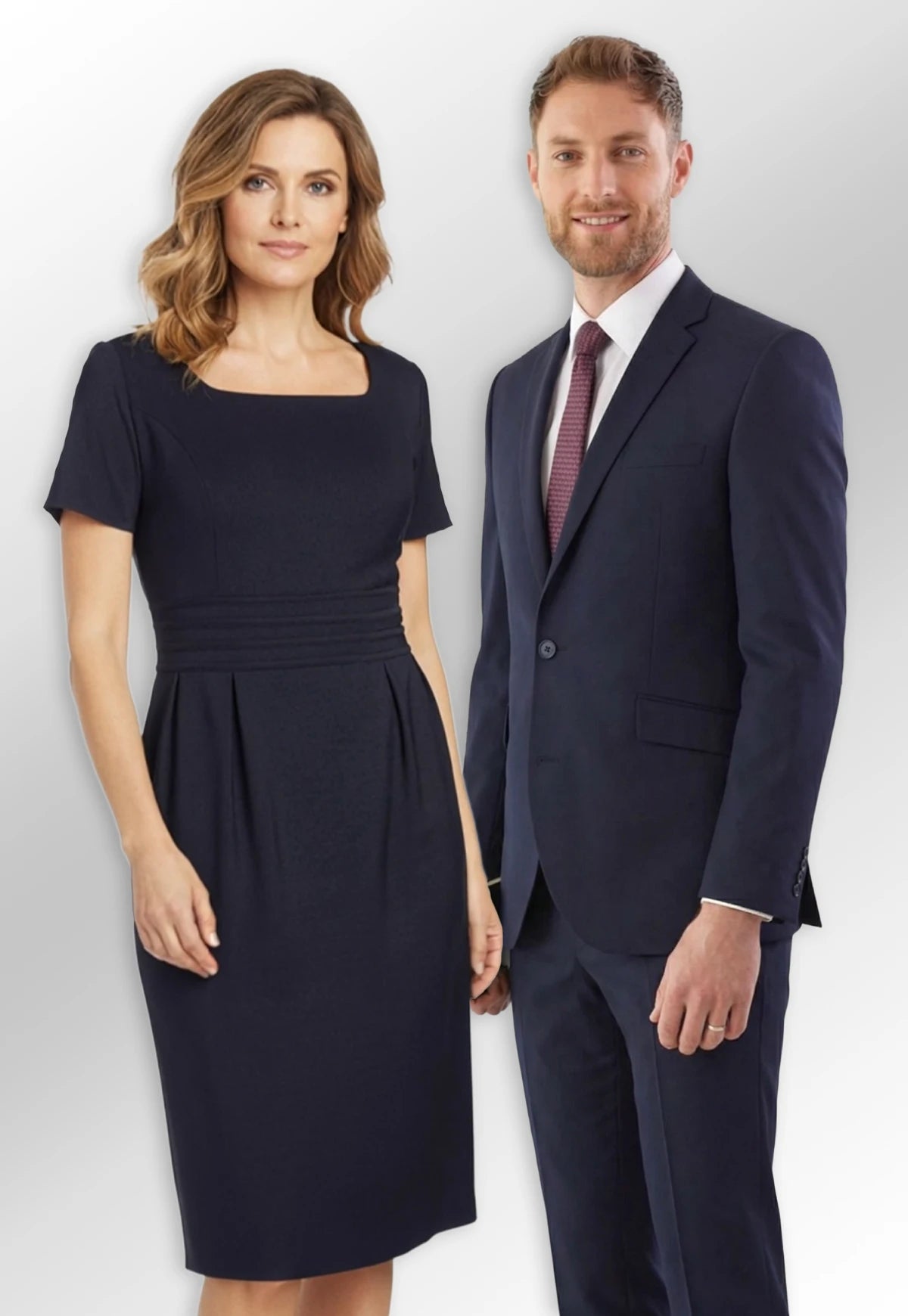 Man and woman in formal business attire from the Brook Taverner Today Collection, standing side by side.