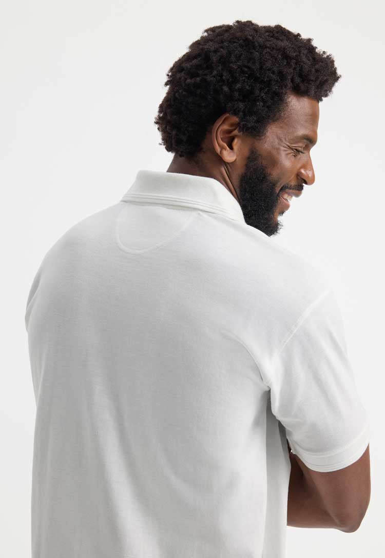 model wearing Ultimate Cotton Polo Shirt  in white close up back view