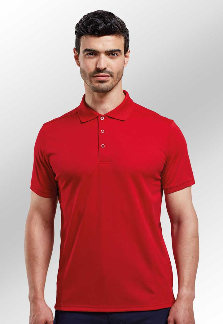 Model wearing Coolchecker® Piqué Polo PR615 in red