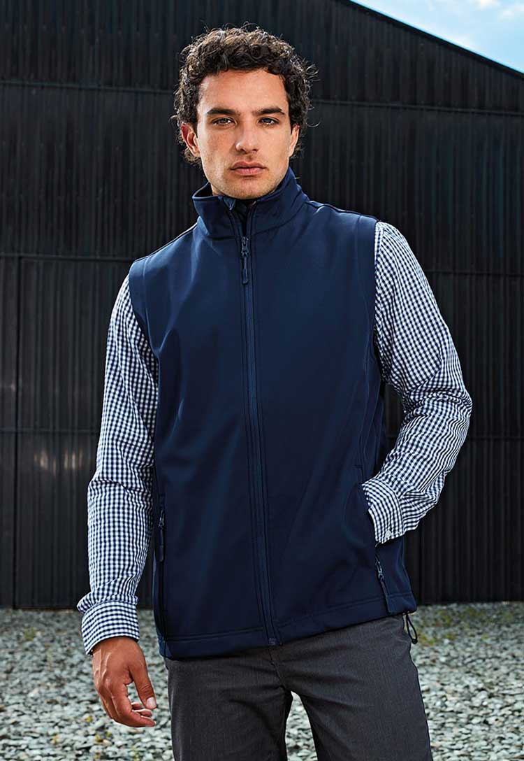 Lifestyle model wearing Windchecker® Printable and Recycled Gilet PR814 in navy