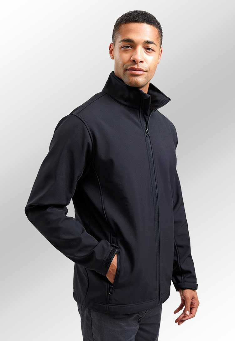 Model wearing Windchecker® Printable and Recycled Softshell Jacket PR810 in black