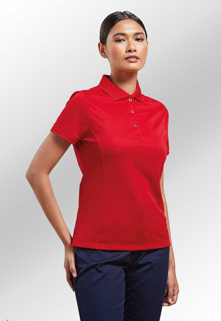 Model wearing Women's Coolchecker® Piqué Polo PR616 in red