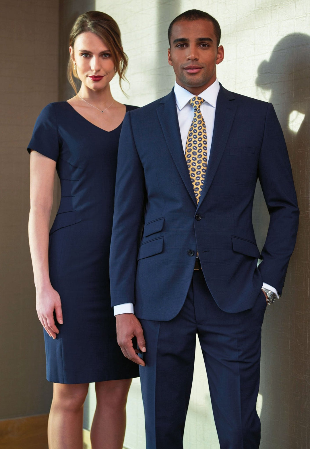 Model in Navy Check Diamante Signature Dress and Men's Signature Suit Worn Side By Side