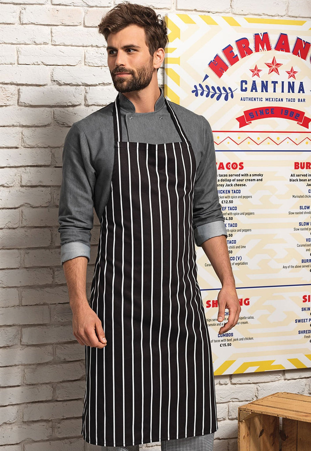 Model Wearing Striped Bib Apron PR110 in Black/White Stripe